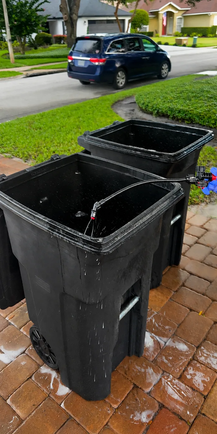 Freshly rinsed trash bins on a driveway