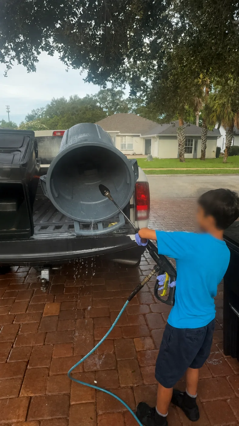 Bin Buddies cleaning a large gray bin