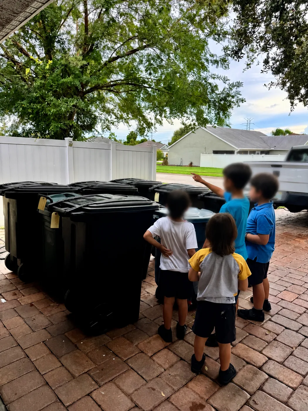 Bin Buddies team beside a group of bins ready for cleaning